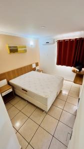 a bedroom with a large white bed in a room at OFERTA - Fiori DiRoma Caldas Novas - Térreo - Parque Aquático 24h in Caldas Novas