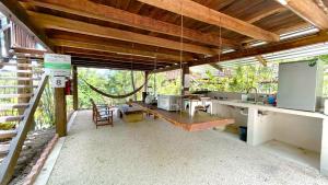 a large kitchen with a counter and a table at Hotel Xu-La Azul in Xul-Ha +4 photos