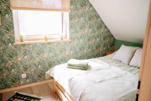 a small bedroom with a bed and a window at Agroturystyka Stara Huta - Domek Boho in Narol +88 photos