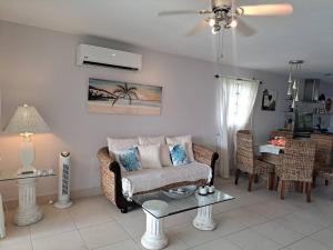 a living room with a couch and a table at Beautiful villa less than 5 minutes from the beach in Jolly Harbour