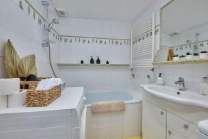 a white bathroom with a tub and a sink at Old Pressburg - Green Courtyard in Bratislava
