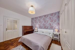 a small bedroom with a bed and a piano at Old Pressburg - Green Courtyard in Bratislava
