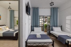 Postel nebo postele na pokoji v ubytování Kings Hersonissos Hotel