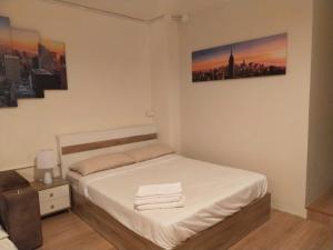 a small bedroom with a bed with white sheets at Bonanza Patong Beach1 100m to Beach Star Room in Patong Beach