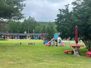 a park with a playground with slides and play equipment at Mount Jefferson View in Randolph