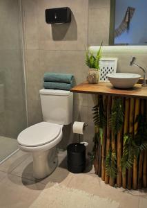 a bathroom with a toilet and a sink at Pousada Maria Parafina Praia do Rosa in Imbituba +35 photos