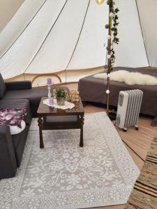 a living room with a tent and a table at Telt 2 in Hattfjelldal