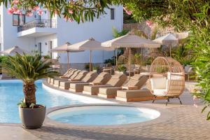 a hotel pool with lounge chairs and a swimming pool at Creta Blue Boutique Hotel in Hersonissos