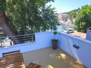 a balcony with a table and a view of a river at Riva in Klenovica