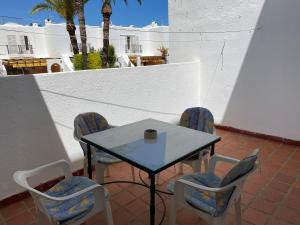 a table and chairs with a coffee cup on a patio at Casa Los Remos in La Marina de la Torre