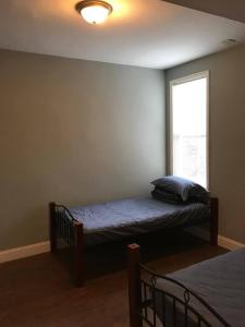 a bedroom with a bed and a window at 202 Private Room-Double Twin Bed in CoHi DC! in Washington