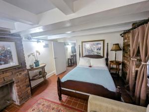 a bedroom with a bed and a fireplace at The Esplanade Guesthouse Mansion in New Orleans