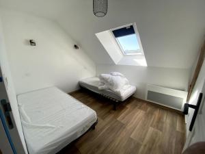 a small room with a bed and a window at Fournil in Chamberet
