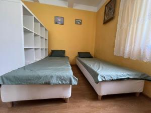 two twin beds in a room with a window at Siedlisko Opoka okolice Sandomierza i Kazimierza Dolnego in Opoka Duża