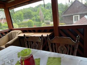 a table and chairs in a room with a window at Siedlisko Opoka okolice Sandomierza i Kazimierza Dolnego in Opoka Duża