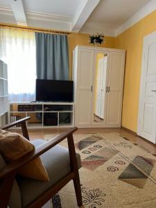 a living room with a tv and a cabinet at Siedlisko Opoka okolice Sandomierza i Kazimierza Dolnego in Opoka Duża