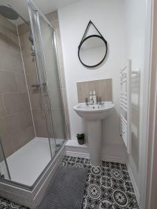a bathroom with a sink and a shower at Two Bedroom Duplex Apartment in Swansea +21 photos
