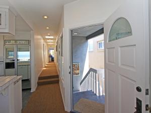 a hallway with a door leading to a staircase at 1023 E Balboa B in Newport Beach +16 photos