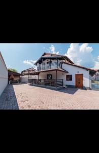 a large white house with a large driveway at Caty in Jiblea Veche +12 photos