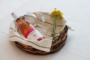 a bottle of wine and two glasses in a basket at ADAYELI BUTIK HOTEL in Karaburun +20 photos
