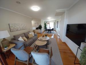 a living room with a couch and a table at PISO DÚPLEX - ISLA DE LA TOJA (O GROVE) in O Grove