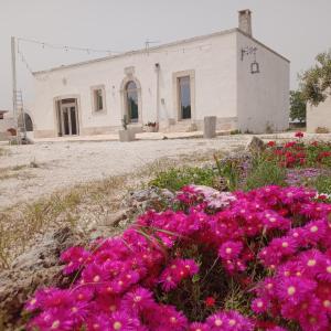 a building with pink flowers in front of it at Villa Nuova 1924 in Mottola