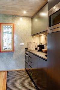 a kitchen with stainless steel appliances and a window at Casas da Fontanheira in Marvão +44 photos