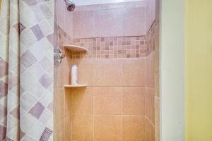 a bathroom with a shower with pink tile at Swim Dock and Views Lakefront Afton Vacation Rental in Afton +19 photos