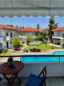 a balcony with a view of a swimming pool at Palm trees apartment in Pefkohori