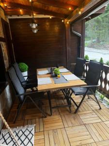 a wooden table and chairs on a patio at Avelov Studio Pamporovo in Pamporovo