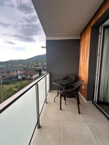 a balcony with a table and chairs and a view at Vivo Residence II in Baia Mare +4 photos