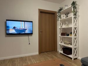 a television hanging on a wall in a living room at Seljani in Pluzine