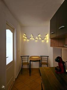 a kitchen with a table and chairs and a window at Harmony Oasis in Gheorgheni +6 photos