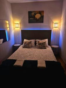 a bedroom with a large bed with two lamps at Harmony Oasis in Gheorgheni