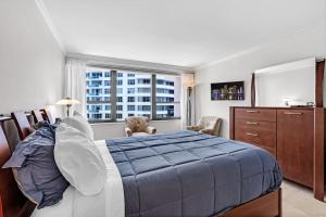 a bedroom with a large bed and a window at 2 Bedrooms Unit OceanFront Resort The Alexander in Miami Beach +64 photos