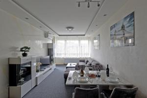 a living room with a couch and a table at Lux Mila with Free Private parking in Novi Sad