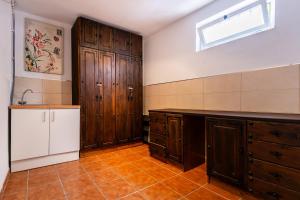 a large kitchen with wooden cabinets and a window at Sweet Home Botanico in Adeje +54 photos