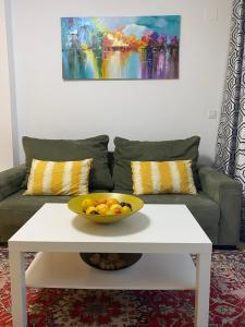 eine Obstschale auf einem weißen Couchtisch in einem Wohnzimmer in der Unterkunft Precioso apartamento con vistas al mar in Benicàssim
