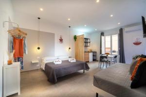 a hotel room with two beds and a kitchen at MamErì central rooms in Castellammare del Golfo