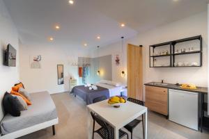 a living room with a bed and a couch and a table at MamErì central rooms in Castellammare del Golfo