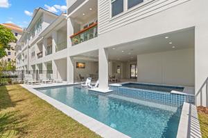 a swimming pool in the backyard of a house at Oynx House & Jade House at the Gemma - 2 Amazing Homes Steps to Clearwater Beach in Clearwater Beach