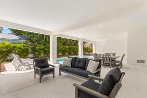 a living room with a couch and chairs and a table at Oynx House & Jade House at the Gemma - 2 Amazing Homes Steps to Clearwater Beach in Clearwater Beach