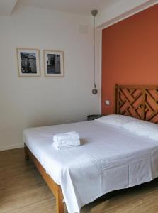 Una cama blanca con dos toallas encima. en Domus Taura civico 48, en Terracina