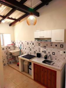 a kitchen with a sink and a counter top at Floripa Beach House Hostel in Florianópolis