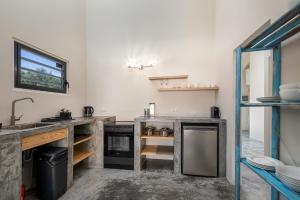 a kitchen with a sink and a counter top at Blue Bonaire by Boutique Bonaire Unique Resorts in Kralendijk