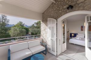 a room with a balcony with a couch and a bed at Villa GALET in Saint Paul de Vence +97 photos