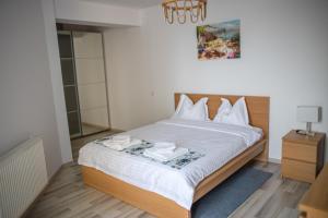 a bedroom with a bed with two towels on it at Olimp 35 in Olimp