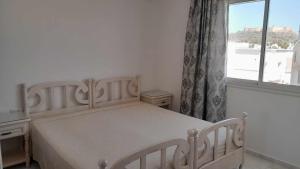 Łóżko lub łóżka w pokoju w obiekcie Appartement Kelibia