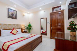 Postel nebo postele na pokoji v ubytování Biển Vàng Vũng Tàu Hotel