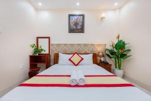 Postel nebo postele na pokoji v ubytování Biển Vàng Vũng Tàu Hotel